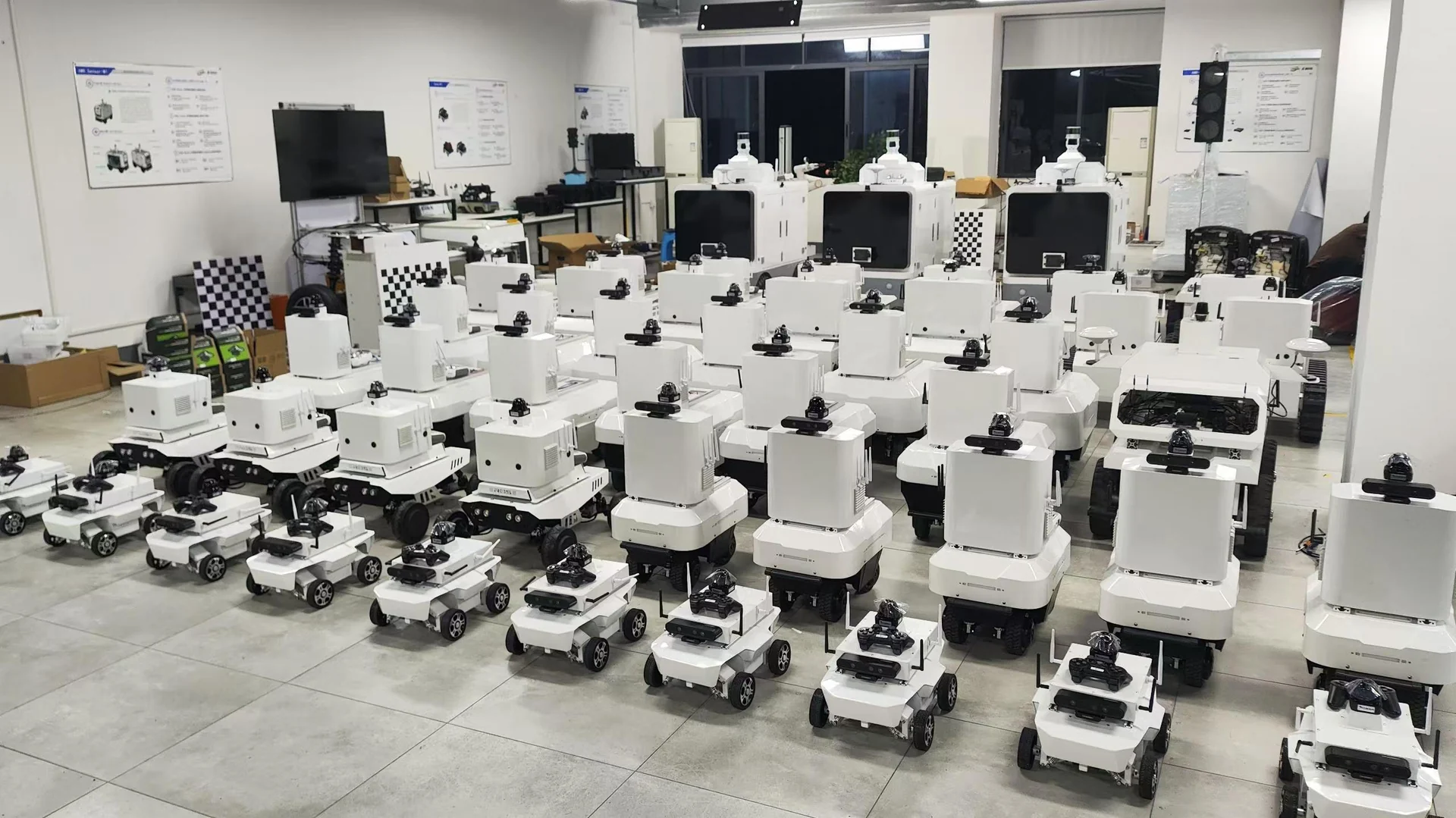 AERISE delivery photograph showing rows of compact and larger ground robots